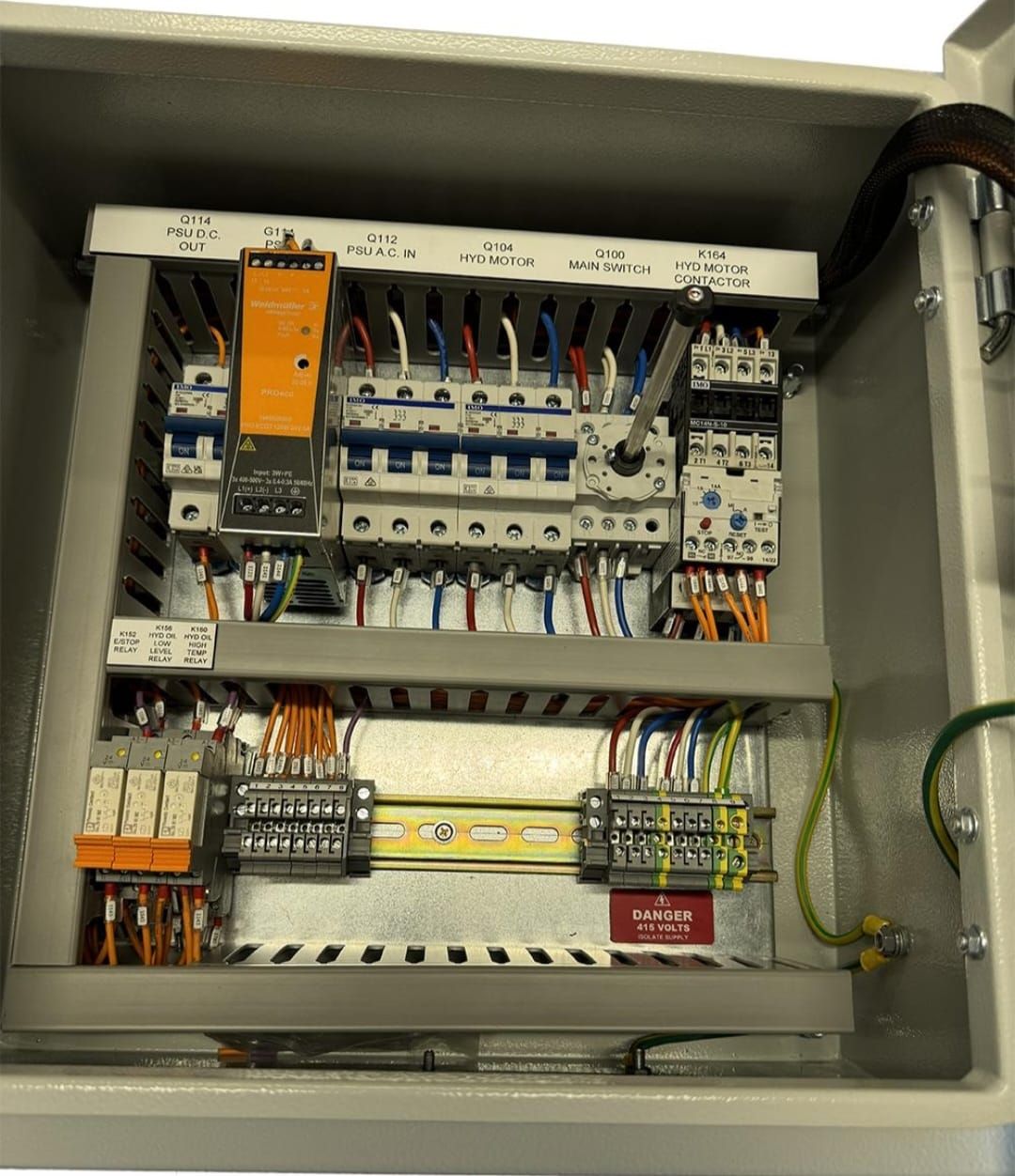 Control cabinet with labelled circuit breakers, PLC power supply and terminal strips